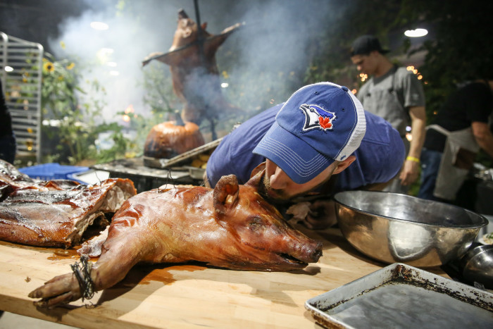 Chef John Horne (Canoe, Toronto) and his Gaspor St Canut Farms suckling pig cooked asado-style (Courtesy of Galdones Photography/Cochon 555)