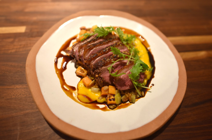 Chef Kevin Adey at Faro in Brooklyn, NY dresses his dry aged duck breast with his variation of fish sauce caramel. (Photo courtesy of Faro.)