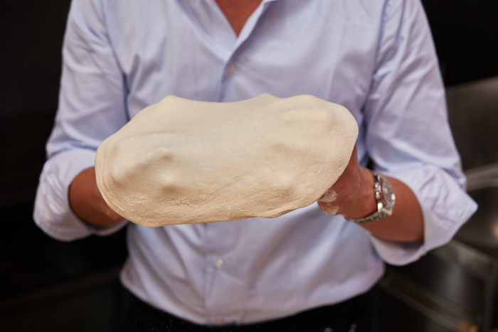 The dough is stretched after it reaches room temperature.