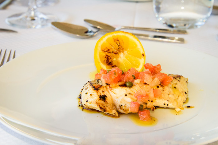 Chef Michel Nischan created several special dishes, like this one featuring a pan-seared filet of local white fish, dressed with lemon, tomatoes, capers, and olive oil. (Photo credit: Steve Schimmelman)