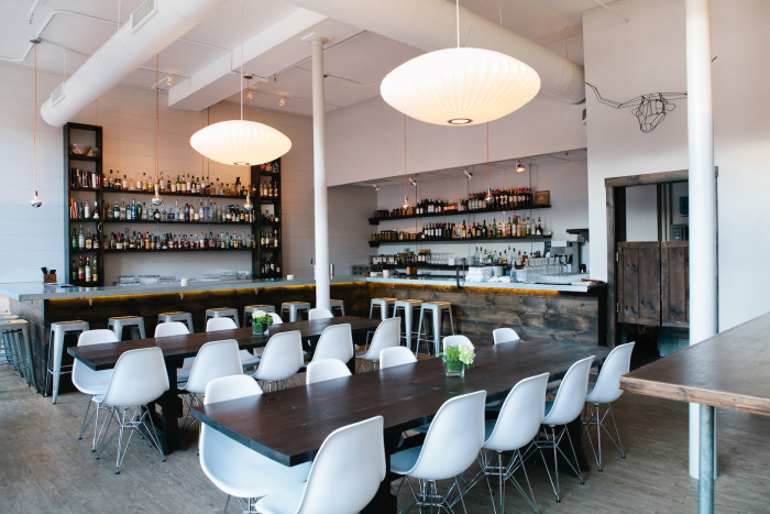 Opened in 2013 by Andrew Volk, this Scandinavian-inspired cocktail bar fittingly features a clean and minimal aesthetic with white walls, communal tables, and Herman Miller pendant lighting and chairs. (Photo credit: Meredith Perdue)