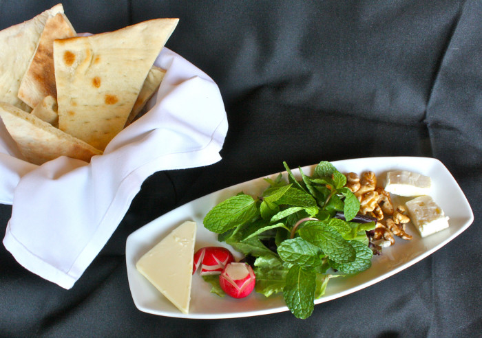 Every meal at Pomegranate On Main begins with a complimentary starter of feta cheese, nuts radishes, and fresh herbs. (Photo credit: Pomegranate On Main)