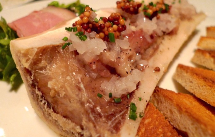 Pickled mustard seeds add acidity and texture to rich, fatty roasted bone marrow. (Photo: arndog on Flickr.)