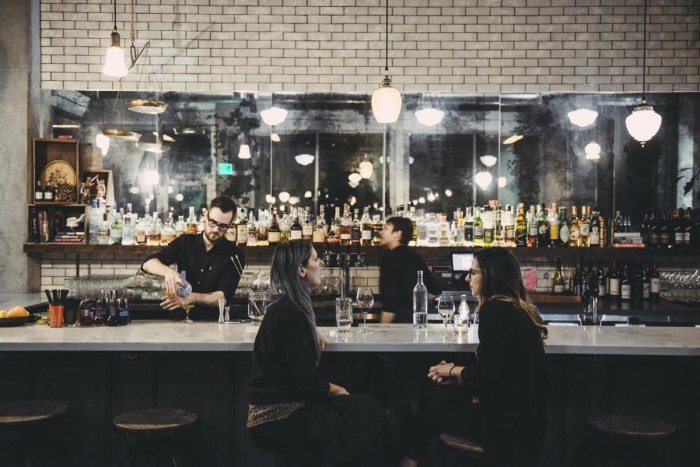 The bar at Rue is perfect for lingering over a well-crafted cocktail and one (or more) of Chef Jason Roberts's vegetable-forward small plates. (Photo credit: Rue)