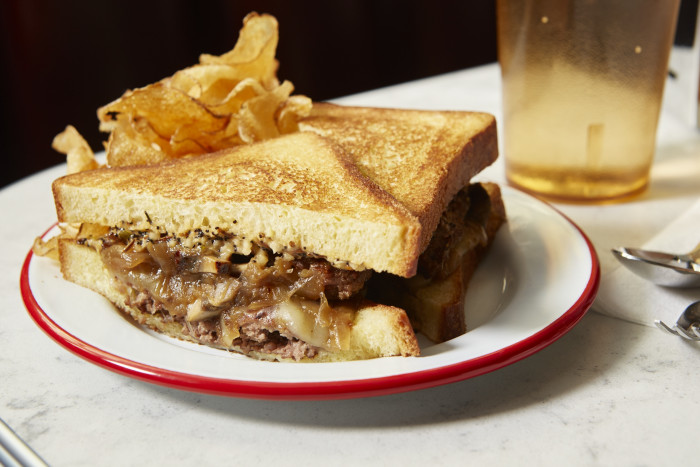 The patty melt comes smothered in everything bagel spiced sauce.