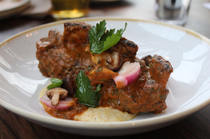 The braised bison short rib at Flintcreek Seattle is finished with pickled mushrooms and parmesan grits. (Photo credit: Flintcreek Seattle)