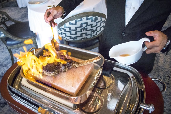 La Table puts the "table" in "table service," with its Akaushi ribeye flambé. (Photo: Mai Pham.)
