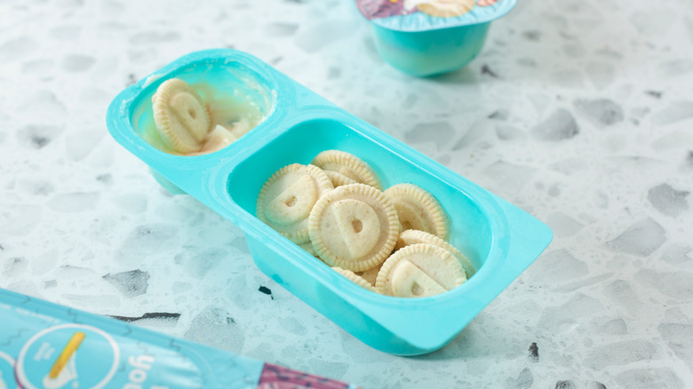 An open package of Dunkaroos, showing cookies and icing in a blue snack tray