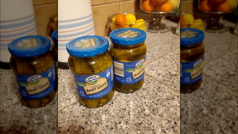 Two jars of Kosher Baby Whole Dill Pickles from Aldi on a countertop