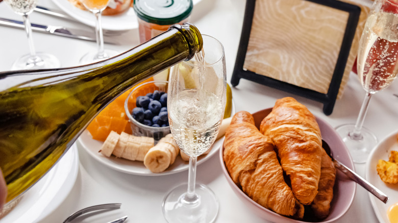 Glass of Champagne surrounded by brunch dishes
