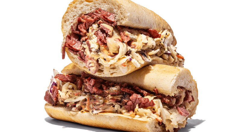 Two halves of Capriotti's Capastrami sandwich are stacked and set against a white background.