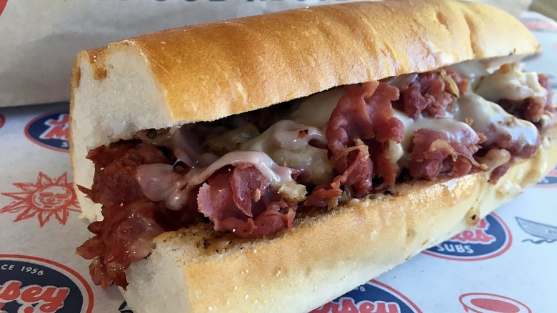 A Jersey Mike's Pastrami Reuben sub is on paper wrapper.