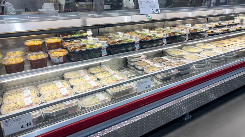 Deli cooler inside Costco full of various prepared foods