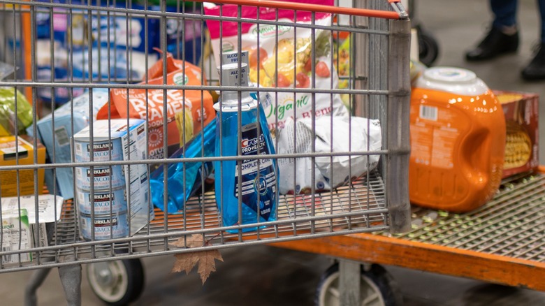 Full shopping cart in busy checkout section of Costco