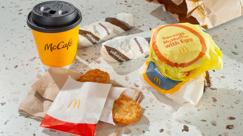 McDonald's breakfast with coffee and hash browns on a counter