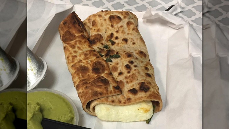 Spinach, Feta & Egg White Wrap from Starbucks on a paper with avocado spread
