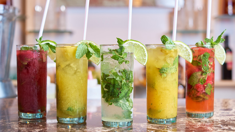 Various tropical cocktails on a bar top
