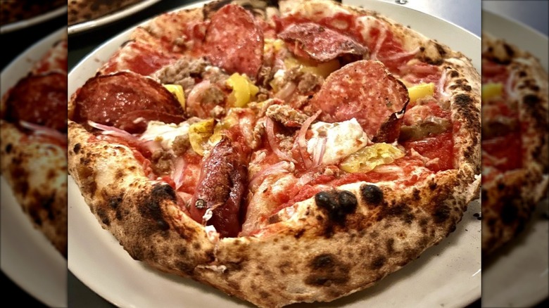 Closeup of a meat pizza with banana peppers