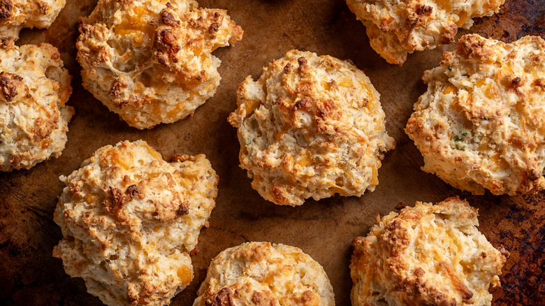 Cheddar drop biscuits on baking sheet