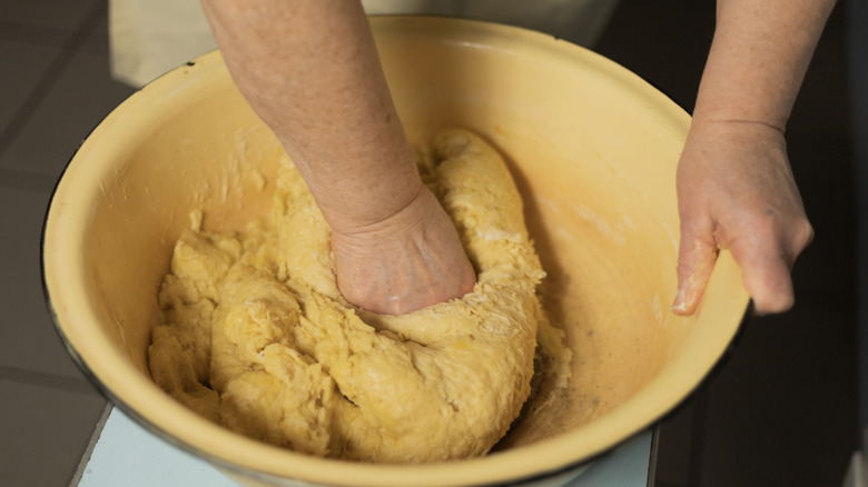 Mixing dough in a large bowl by hand