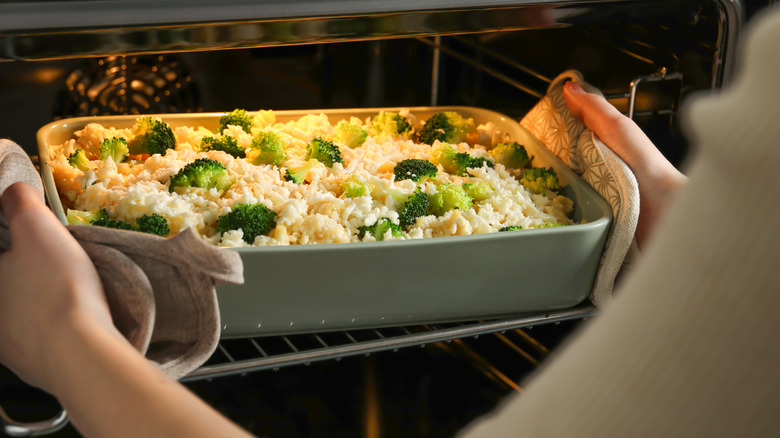 Uncooked pasta casserole going into an oven
