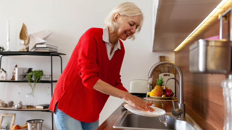 Senior woman washing dishes