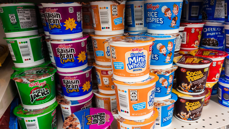Collection of single serving cereal cups in various flavors on store shelf