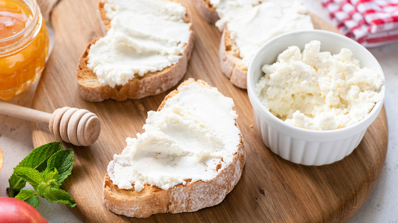 Ricotta cheese on crostini assembled on cutting board