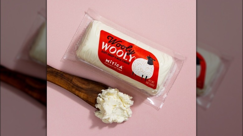 Package of Wooly Wooly cheese on pink background