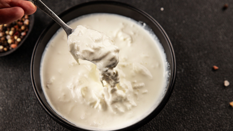 Bowl of stracciatella against black counter