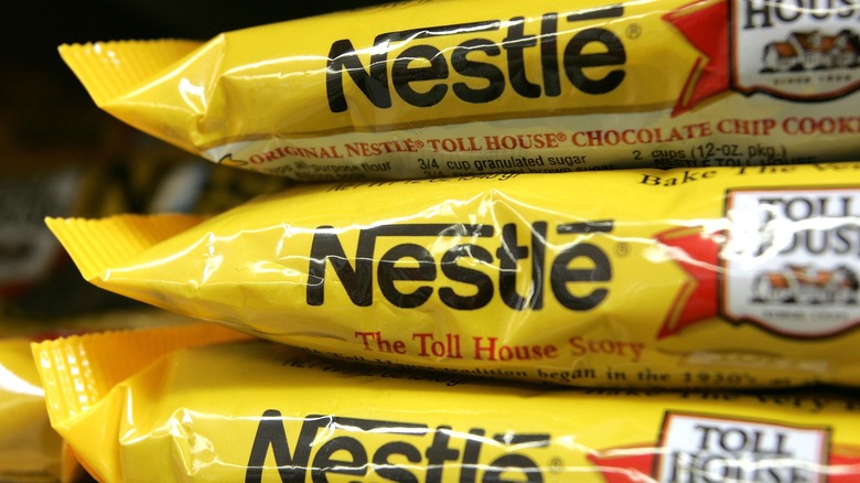 Three bags of Nestle Toll House chocolate chip cookies stacked on top of one another