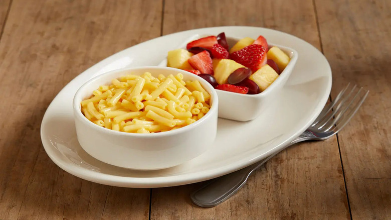Dish of BJ's Restaurant and Brewhouse mac and cheese with a side of fruit