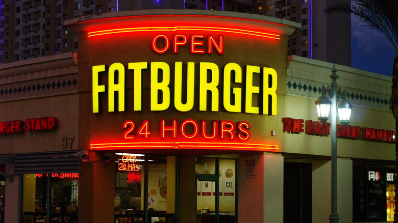 Glowing Fatburger sign promoting 24 hour service