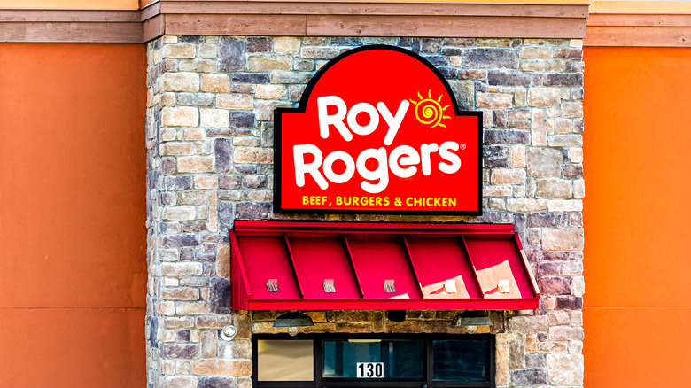 Bright red Roy Rogers sign over a restaurant door