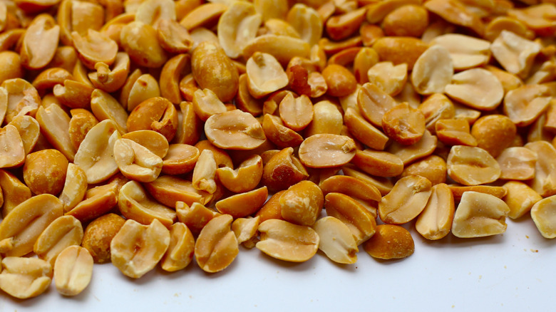 Honey-roasted peanuts spread out on a counter top