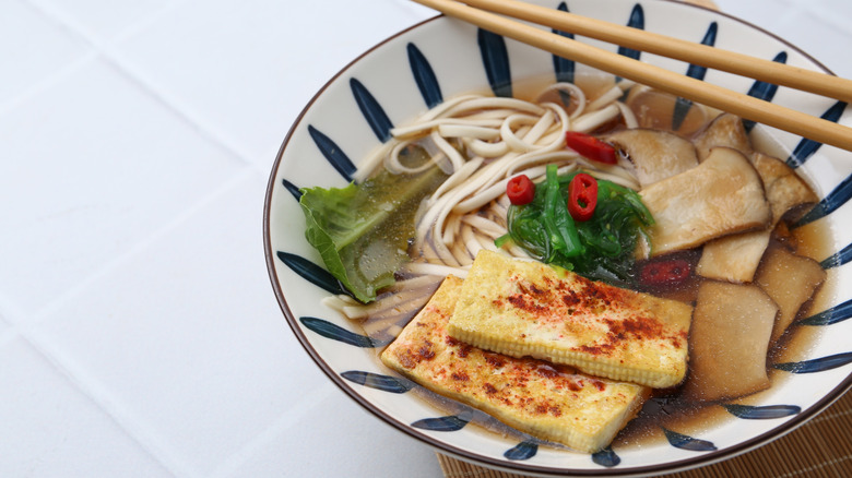 Ceramic bowl of ramen with mushrooms and tofu