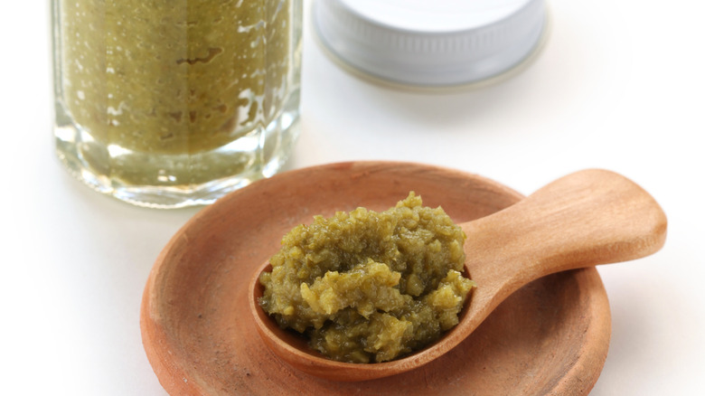 Small wooden spoonful of green yuzu kosho sauce