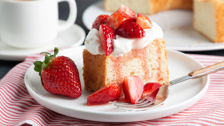 Angel food cake topped with strawberries and syrup