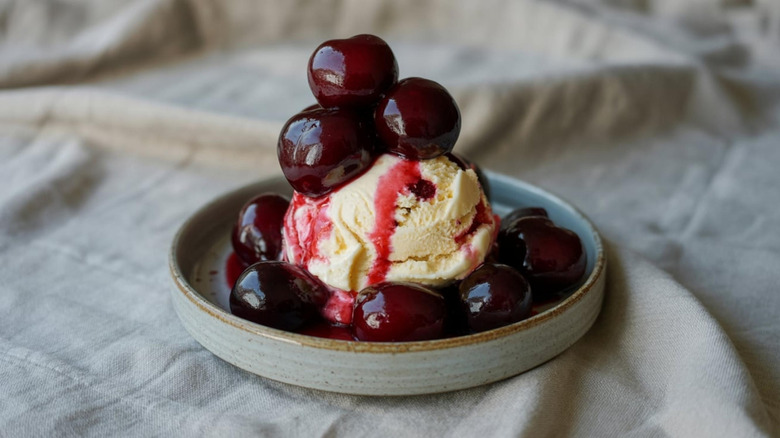 Vanilla ice cream with cherries and syrup