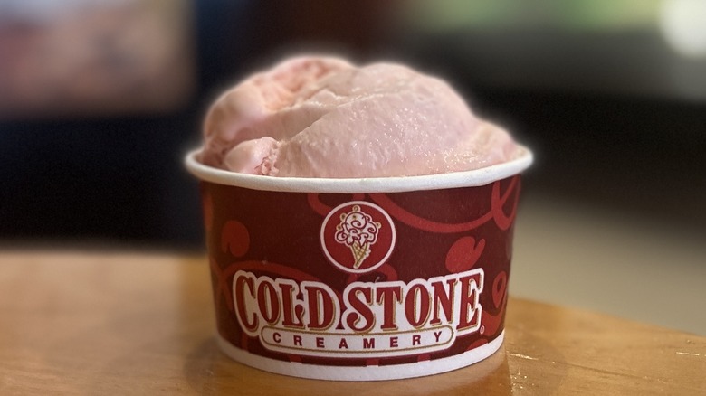 Cold Stone Strawberry Ice Cream in a small cup on a wooden table