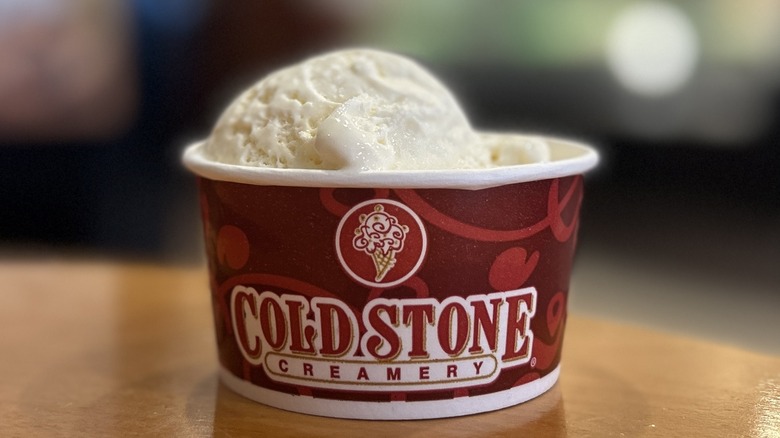 Cold Stone Cheesecake Ice Cream in a small cup on a wooden table