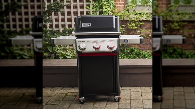 A Weber Spirit EP-325 Gas Grill sits in an outdoor patio setting.
