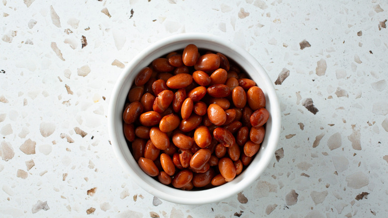 A top down view of a bowl of canned pinto beans