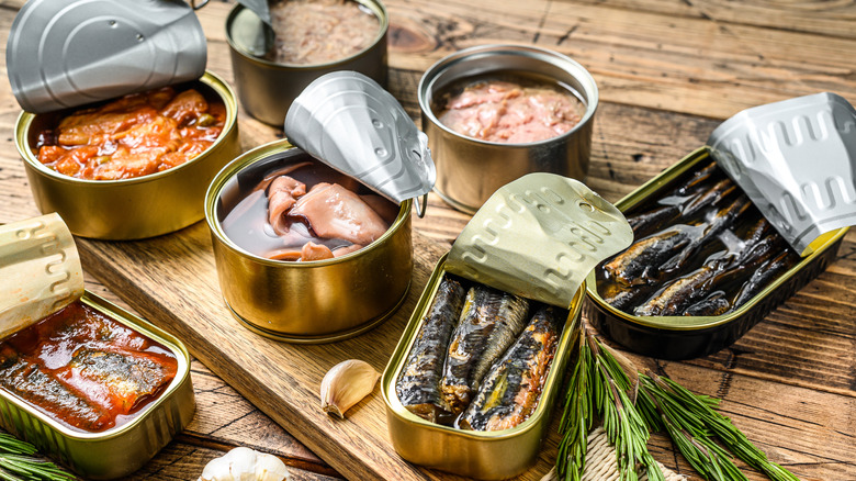 A range of tinned fish on a wooden table