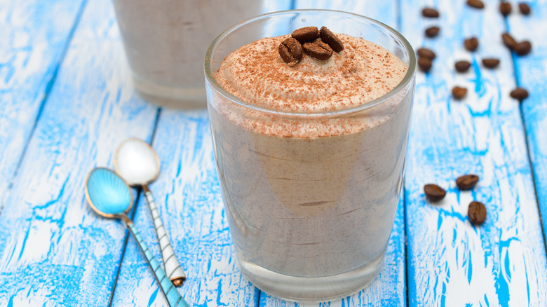 A glass of coffee mousse garnished with coffee beans
