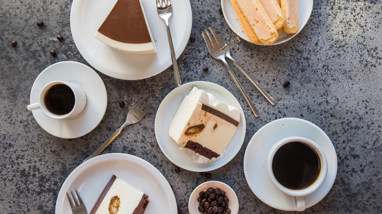 Overhead view of various desserts and cups of coffee