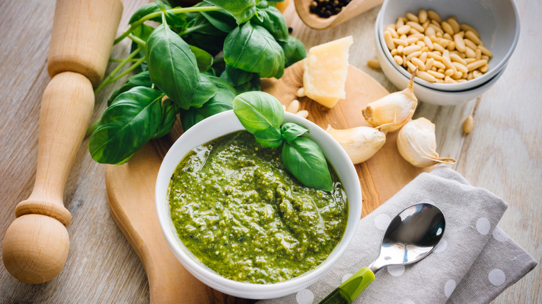 Small bowl of fresh pesto with ingredients on counter