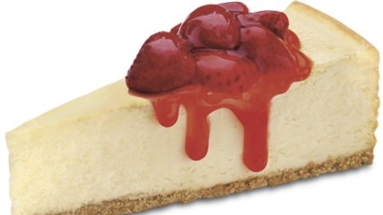 Cheesecake slice topped with strawberry sauce