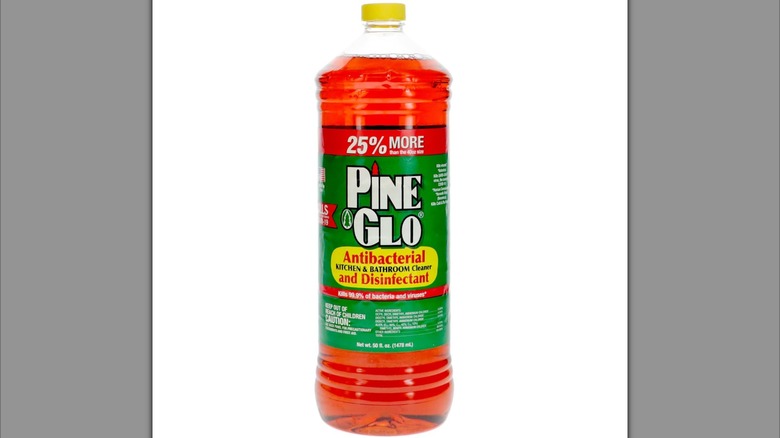 A bottle of Pine Glo disinfectant sits against a white background