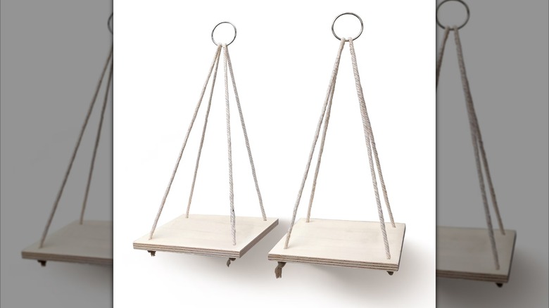 Square wooden shelves suspended from ropes with a metal loop at the top for hanging